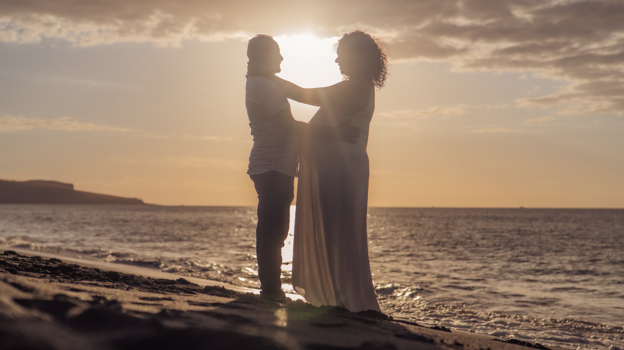 Couple lors d'une séance grossesse au coucher du soleil